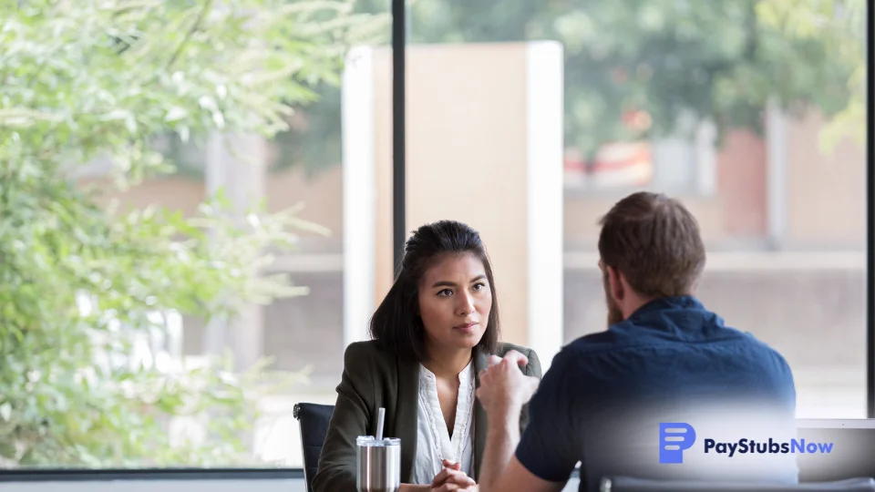 An independent contractor meets with a client at a cafe