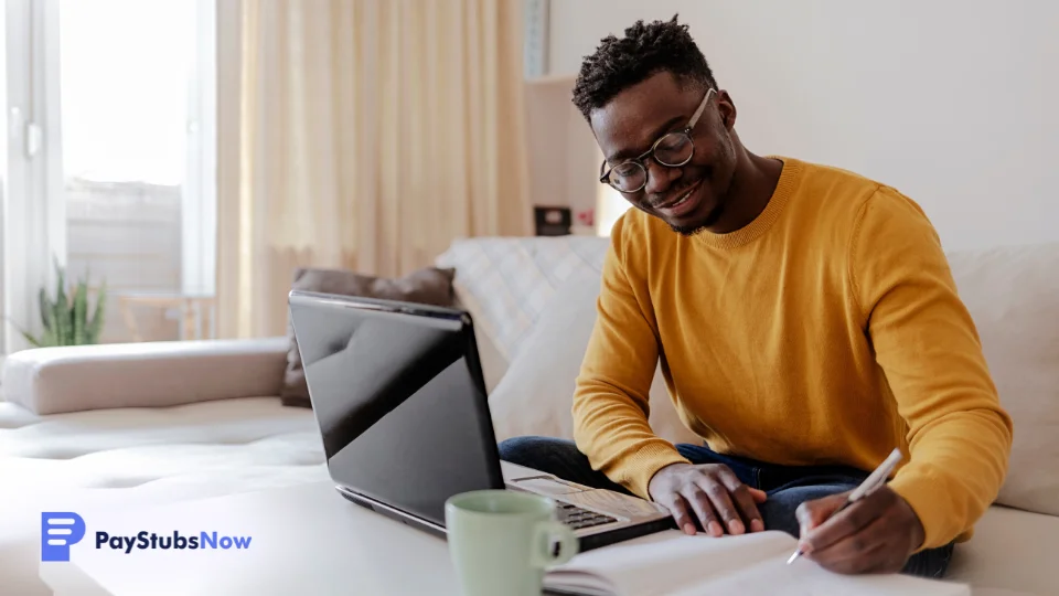 a person sitting at a table with a laptop and a calculator