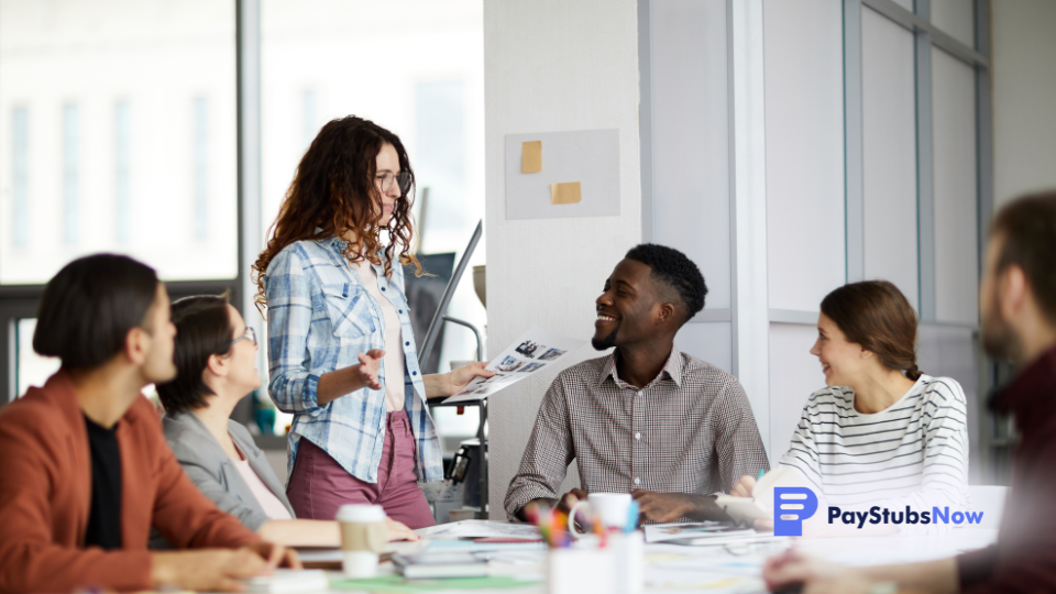 a group of people sitting around a table in an office