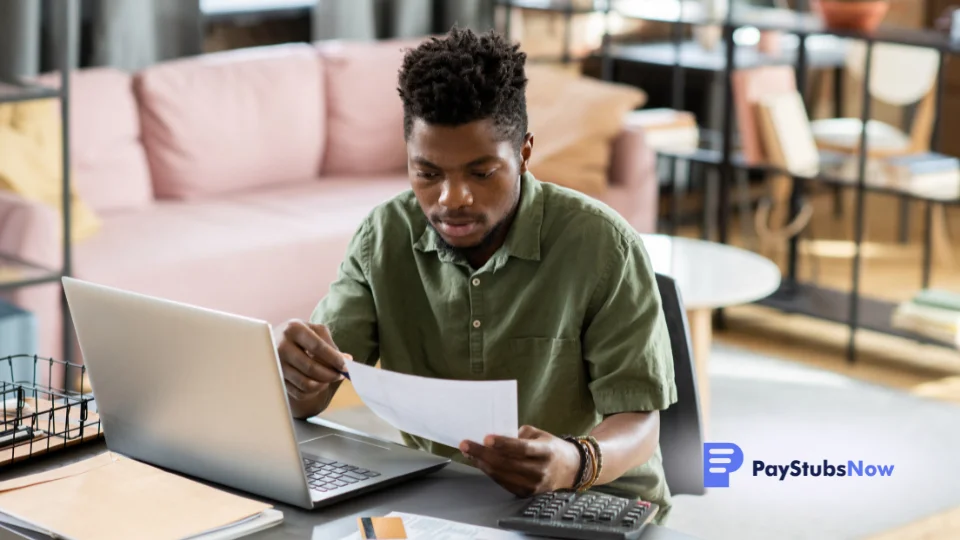 A person working on a laptop in an office