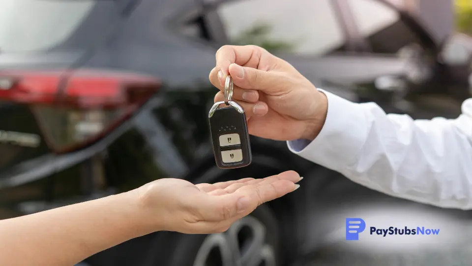 a person handing a car key to another person