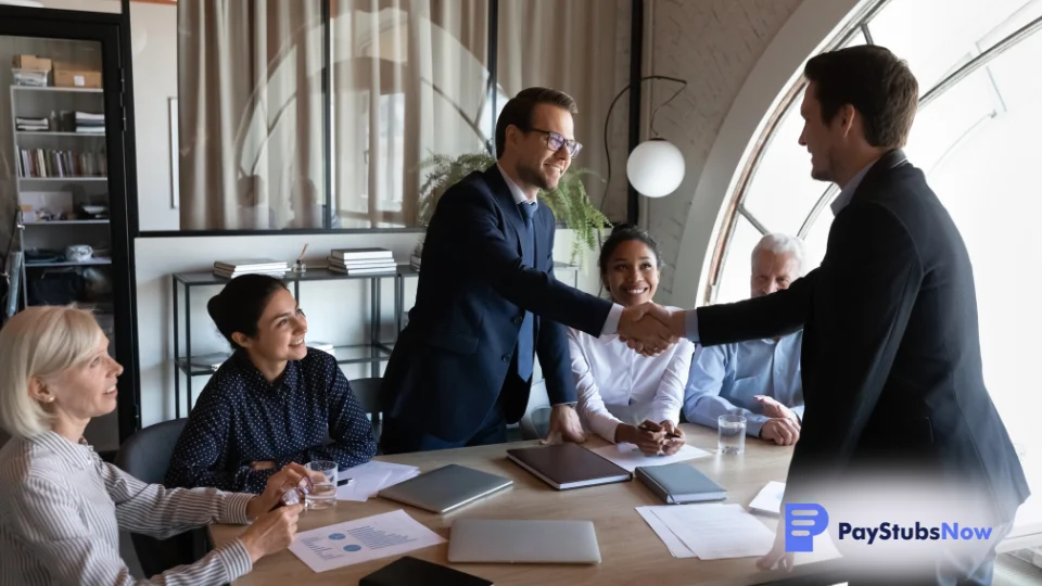 An HR team shakes hands with a PEO representative